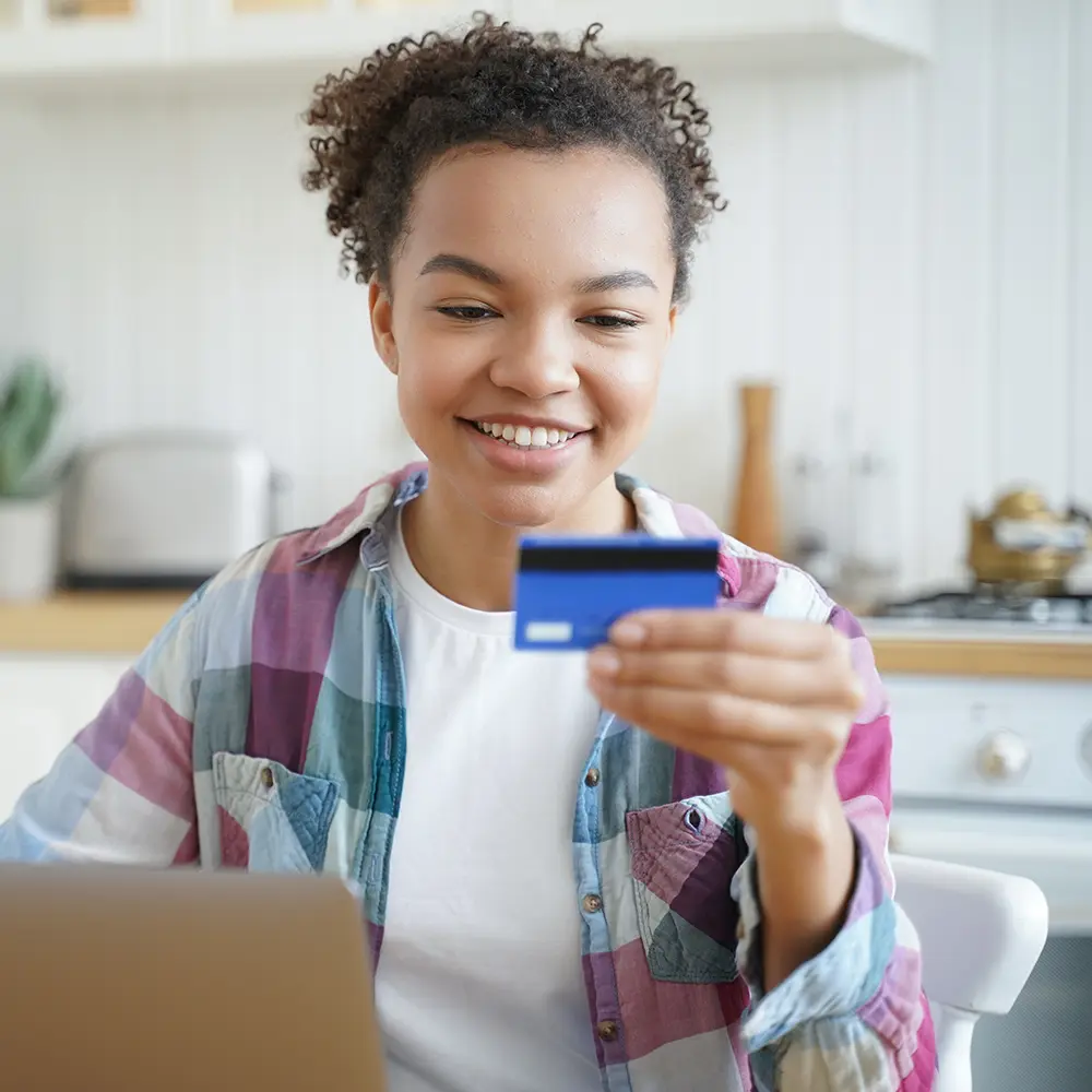 teen holding debit card
