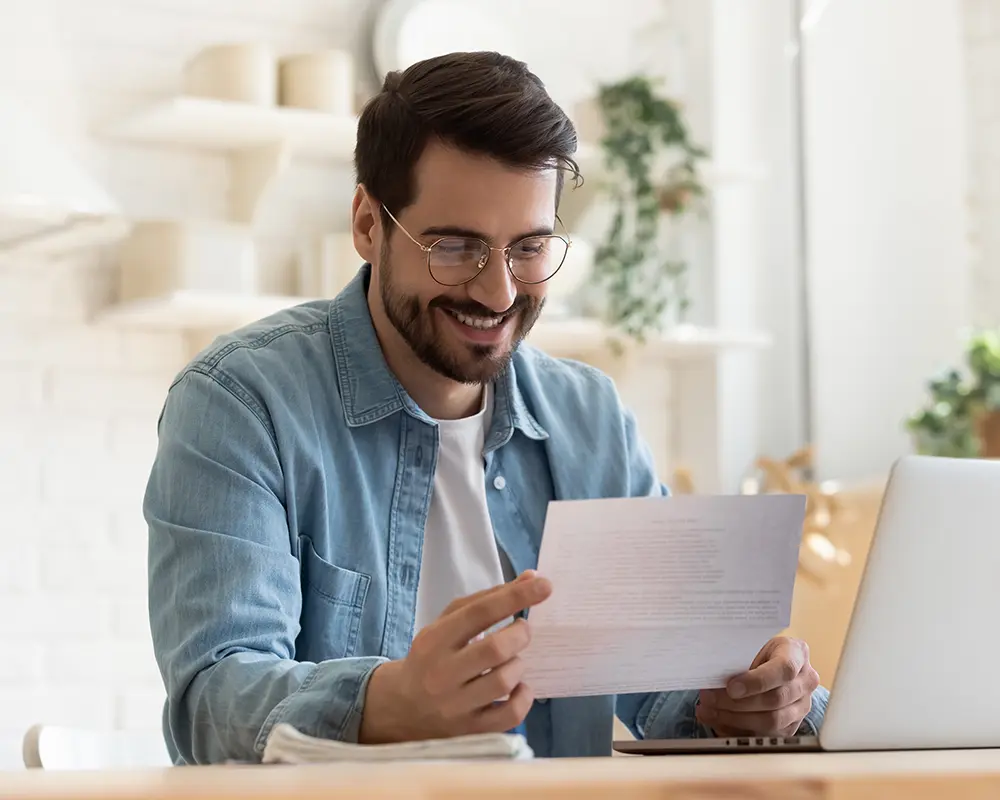 smiling man at laptop